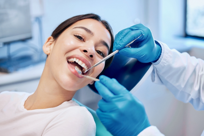 Woman smiling in dentist chair no longer fearing dentist due to The Wand