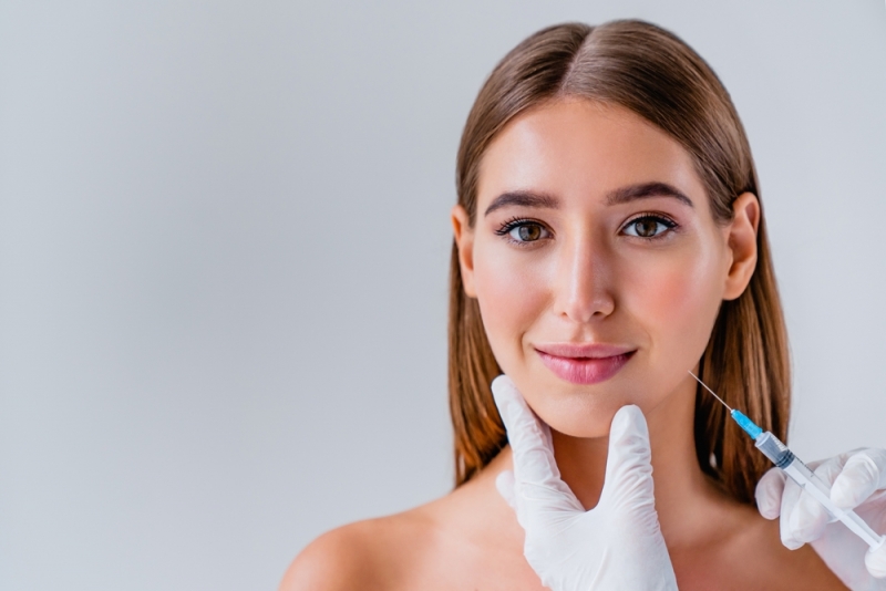 Woman receiving BOTOX injections in the jaw area for TMJ disorder treatment